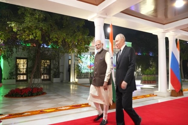 The inside images of PM Modi and Putin walking on red carpets inside the offcial residence of PM . (Image Source: ANI)