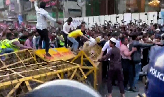 A large number of people, under the banner of "July Oyikko" (July Unity), hold a protest march to the Indian High Commission, in Dhaka on Wednesday. (ANI Video Grab)