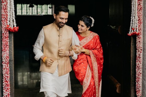 A first look at the newly weds! Samantha was resplendent in a stunning red silk saree while Raj looked dapper in a white kurta with a beige Nehru coat. The couple was glowing with an inner, uncontainable joy. (Image source: Samantha Ruth Prabhu/Instagram)