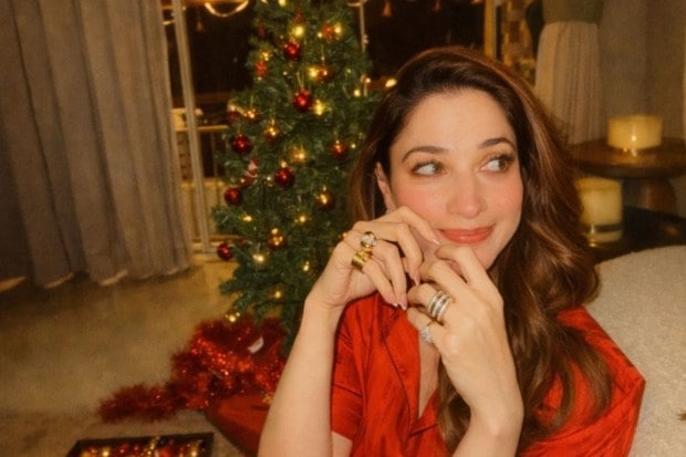 Tamannaah Bhatia spent Christmas 2025 shining like the star atop her Christmas tree. Draped in red satin, she truly embodied the festive spirit with gingerbread cookies and marshmallows. (Image: Instagram)