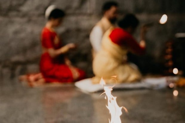 An artistic shot which captured the poignant burning of the ritual flame while the couple bent their heads and folded their arms in prayer. (Image source: Samantha Ruth Prabhu/Instagram)