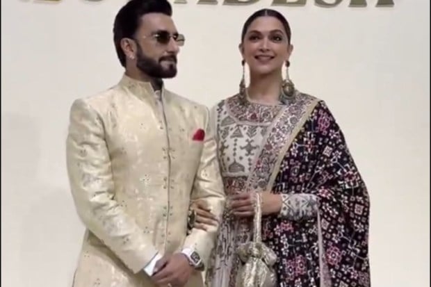 The embodiment of Bollywood royalty, Dhurandhar star Ranveer Singh, posed with wife and actress Deepika Padukone. She stunned in an iconic patola stroll, honouring the Gujarati artisans. (Image: X)