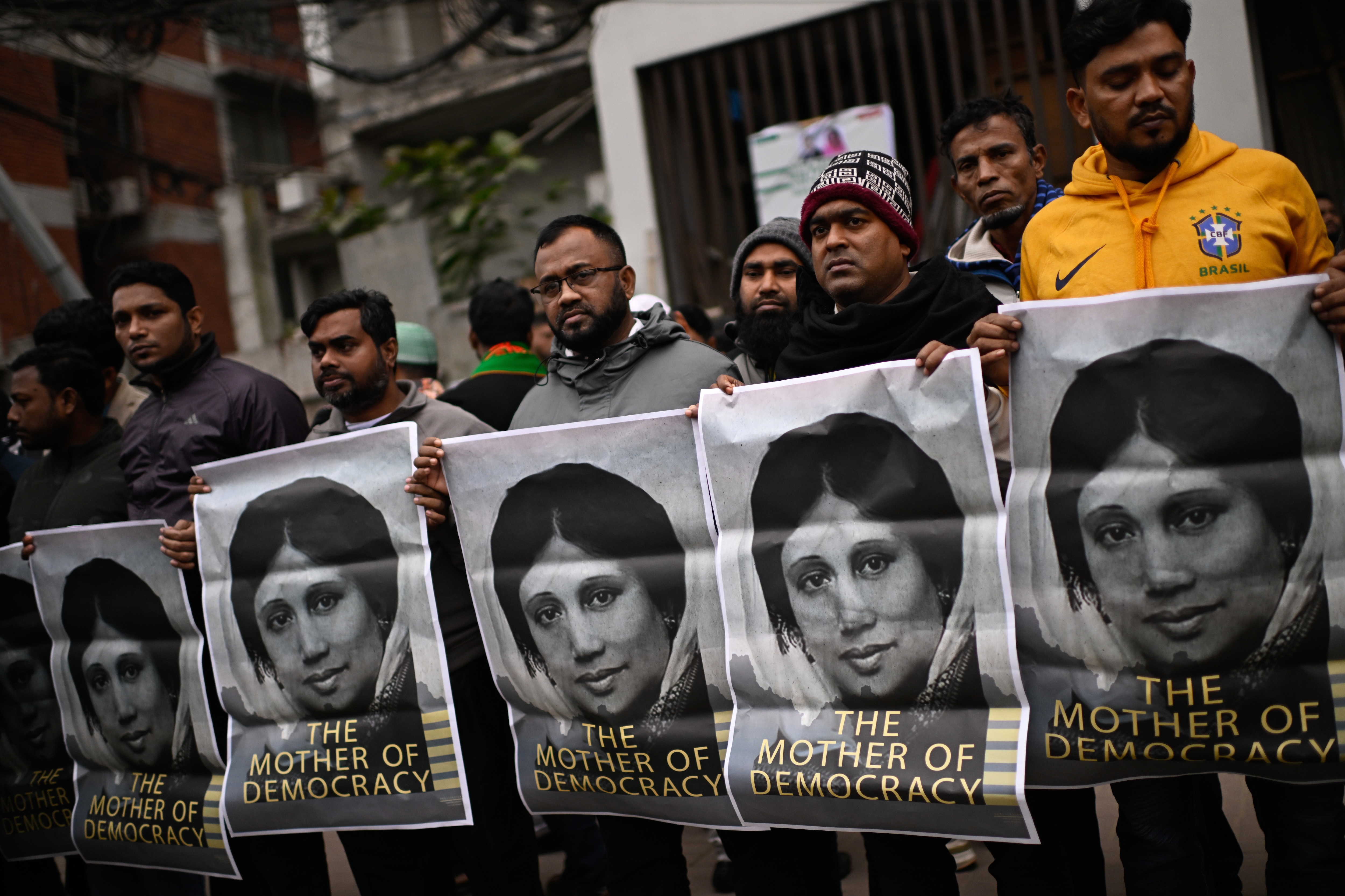 Supporters hold portraits of former Bangladeshi Prime Minister Khaleda Zia outside the hospital where she died (Photo: AP)