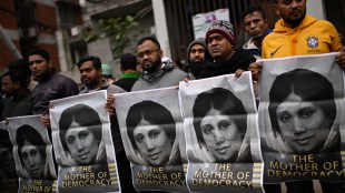 Supporters hold portraits of former Bangladeshi Prime Minister Khaleda Zia outside the hospital where she died (Photo: AP)