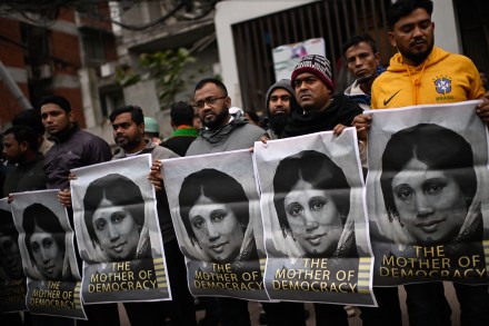 Supporters hold portraits of former Bangladeshi Prime Minister Khaleda Zia outside the hospital where she died (Photo: AP)