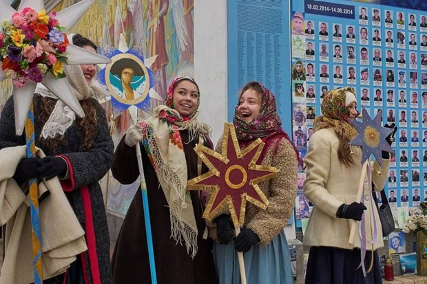 Girls wearing traditional dress and celebrating Christmas near St. Michael Monastery in central Kyiv, Ukraine.