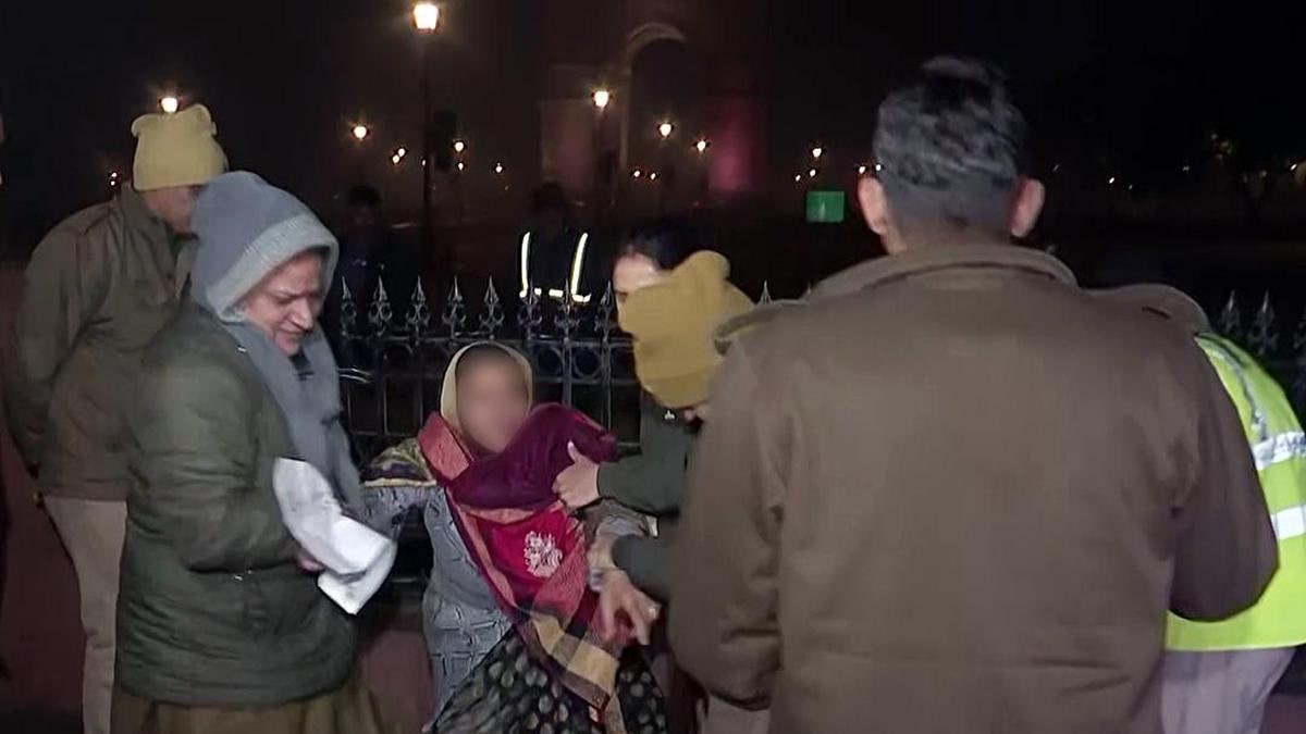 Delhi Police detain the mother of Unnao rape case victim as she protests at India Gate in New Delhi on December 23, 2025 against the Delhi High Court order suspending the sentence of case convict Kuldeep Singh Sengar.