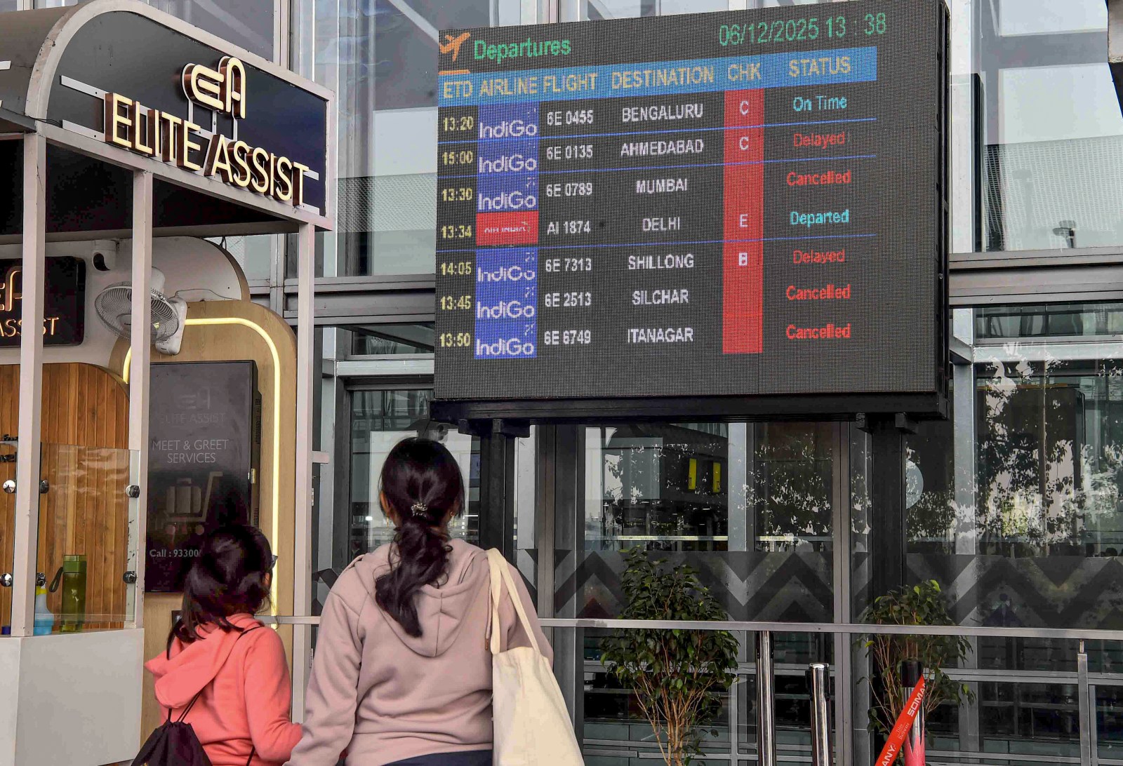 Passengers check updates on the display board amid IndiGo flight disruptions, at Netaji Subhash Chandra Bose International Airport in Kolkata, Saturday, Dec. 6, 2025. (PTI Photo)