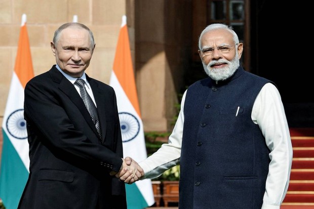 Prime Minister Narendra Modi shakes hands with Russian President Vladimir Putin. (Photo source: ANI)