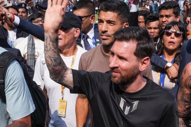 Argentine football great Lionel Messi waves to the crowd at the Salt Lake Stadium during his GOAT India Tour 2025 appearance in Kolkata. (Image: ANI)