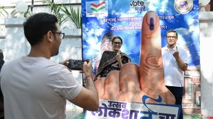 Maharashtra Election Results Vote Counting Begins: A man takes a photograph as voters show their inked fingers at an awareness installation during the Municipal Corporation elections in Mumbai (Photo: ANI)