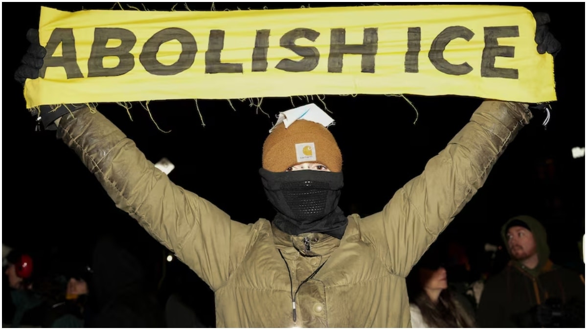 A person holds a banner as people march during a demonstration against increased immigration enforcement. (Image source: Reuters) A person holds a banner as people march during a demonstration against increased immigration enforcement. (Image source: Reuters)