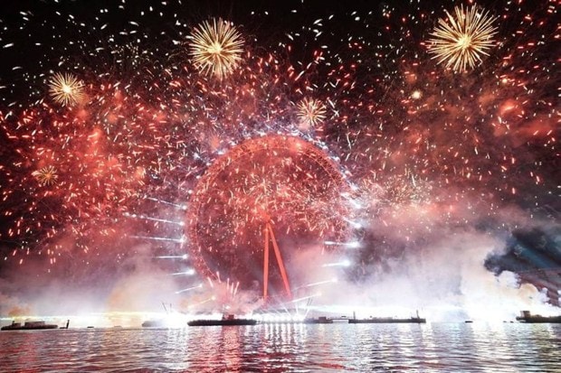 The London Eye, also known as the Millennium Wheel, is seen against a background of bursts of colours, as fireworks light the sky during the New Year celebrations in central London. (Photo source: AP).