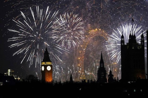 Fireworks arch over central London’s skyline as crowds gather along the Thames to celebrate the New Year. (Photo source: AP)