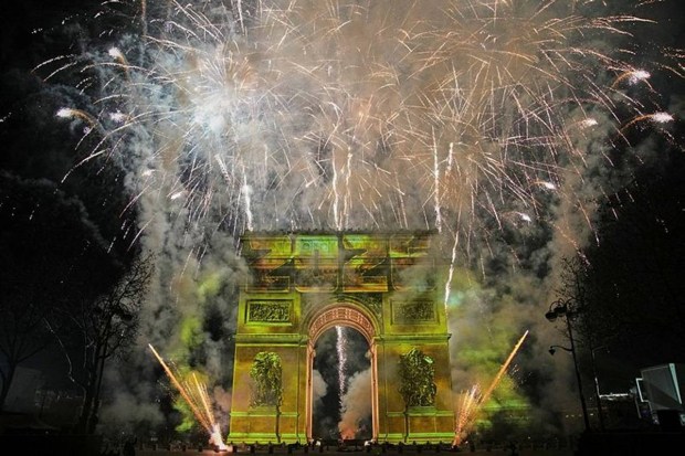A vivid light show on the Arc de Triomphe along with fireworks along the Champs-Elysees during the Paris’s New Year celebrations. (Photo source: AP)