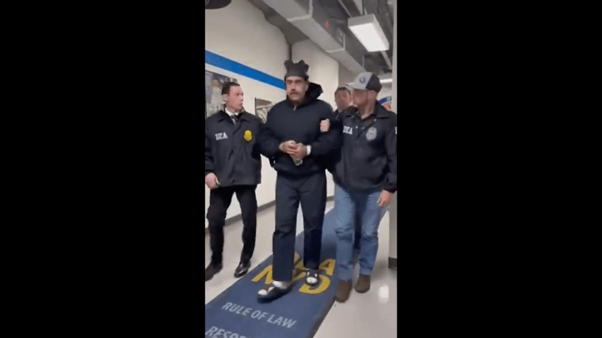 First Images l Thumbs up in handcuffs - Maduro arrives in US, perp walked (X video screengrab) First Images l Thumbs up in handcuffs - Maduro arrives in US, perp walked (X video screengrab)
