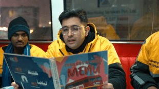 Raghav Chadha wearing a quick-commerce delivery jacket while riding a two-wheeler with a gig worker in Delhi during his night delivery shift.