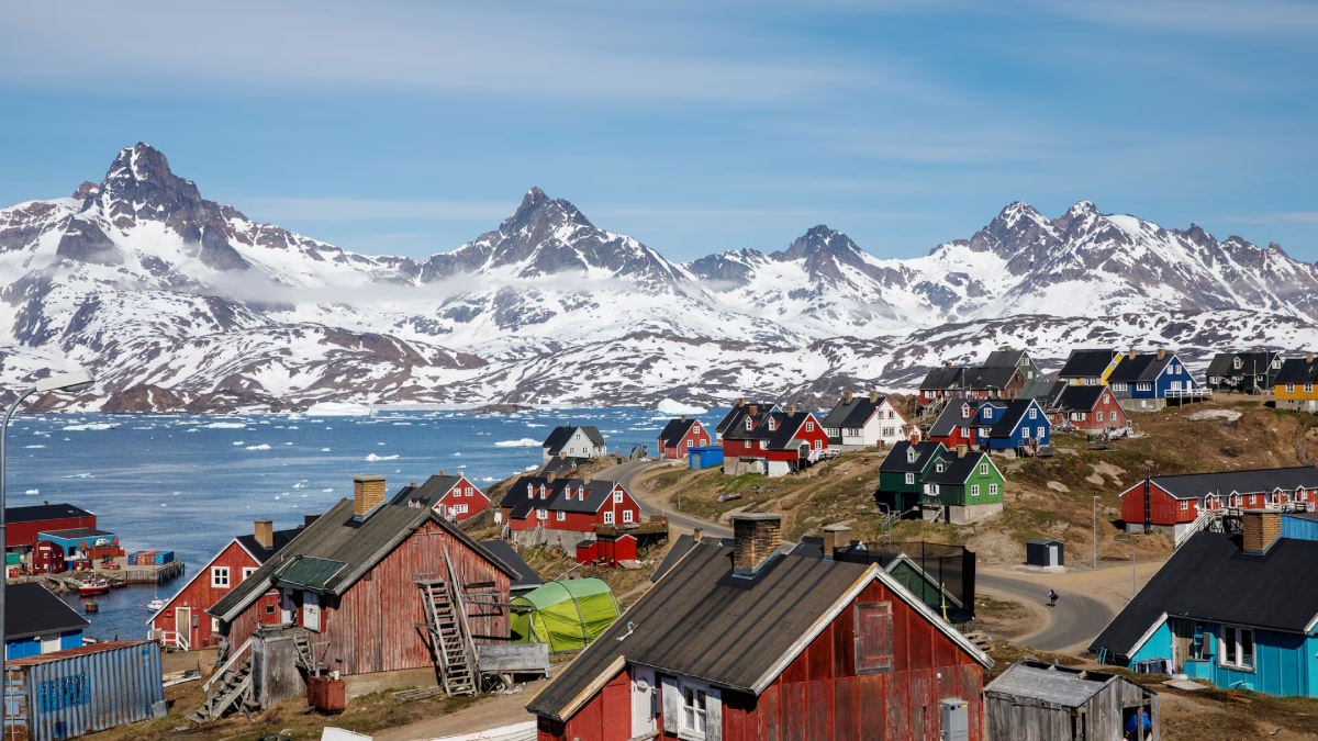 Snow covered mountains rise above the harbour and town of Tasiilaq. Greenland lacks basic infrastructure for its tiny population of 56,000 (Image source: Reuters) Snow covered mountains rise above the harbour and town of Tasiilaq. Greenland lacks basic infrastructure for its tiny population of 56,000 (Image source: Reuters)