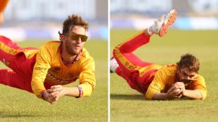 Zimbabwe's Brian Bennett airborne at deep mid-wicket, sporting sunglasses, taking a spectacular diving catch against Oman in the 2026 T20 World Cup