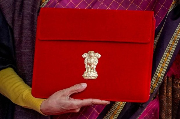 Finance Minister Nirmala Sitharaman shows the digital tablet, enclosed in a traditional red 'bahi-khata' style pouch, outside the Ministry of Finance before the presentation of the ‘Union Budget 2026-27’. (Photo source: PTI)