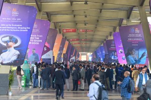 Delegates and workers stand in a queue to get in for the AI-Summit in New Delhi (Photo: AP)