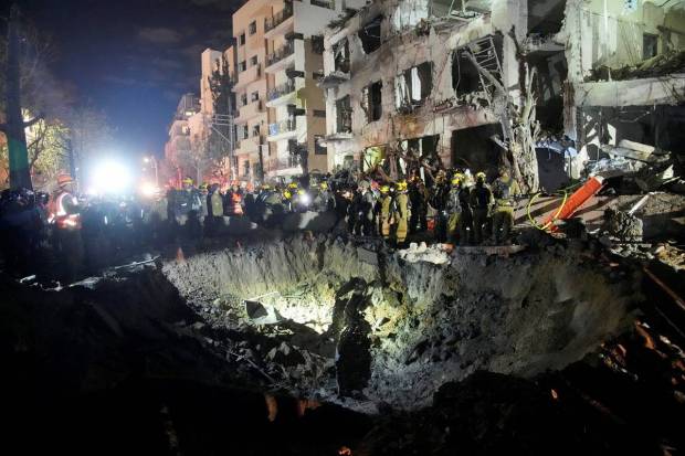 Early on Sunday, March 1, 2026, Israeli Home Front Command officers comb through the debris of a destroyed apartment complex following an Iranian missile strike in Tel Aviv, Israel. (Photo source: AP)