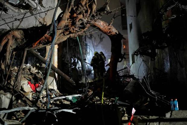 Israeli Home Front Command officers searching through the debris of a destroyed apartmentcomplex following an Iranian missile strike in Tel Aviv, Israel. (Photo source: AP)