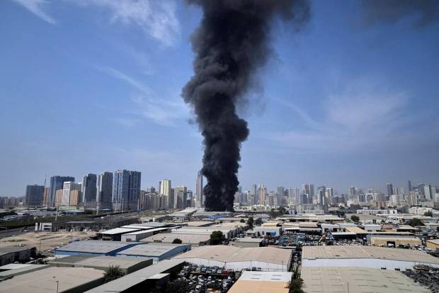 Following news of Iranian strikes in Dubai, United Arab Emirates, on Sunday, March 1, 2026, a black cloud of smoke rises from a warehouse in Sharjah City's industrial district. (Photo source: AP)