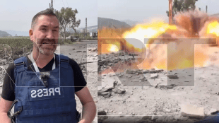 A missile struck mere metres away from the Russia Today reporter and his camera operator as they covered Israeli attacks on southern Lebanon on Thursday (RT video screengrab)