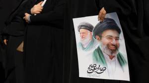 A woman holds an image of Iran's new supreme leader, Mojtaba Khamenei, alongside late Iranian Supreme Leader Ayatollah Ali Khamenei, during a funeral ceremony for the Iranian military commanders who were killed in recent strikes (Photo: Reuters)
