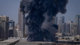 A black plume of smoke rises from a warehouse in the industrial area of Sharjah City on March 1 (Representational image/AP)