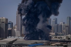 A black plume of smoke rises from a warehouse in the industrial area of Sharjah City on March 1 (Representational image/AP)