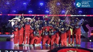 RCB players celebrate IPL title win as fans in red and gold fill the stadium, symbolising the franchise’s rise to a $2 billion valuation and massive fan-driven brand success.