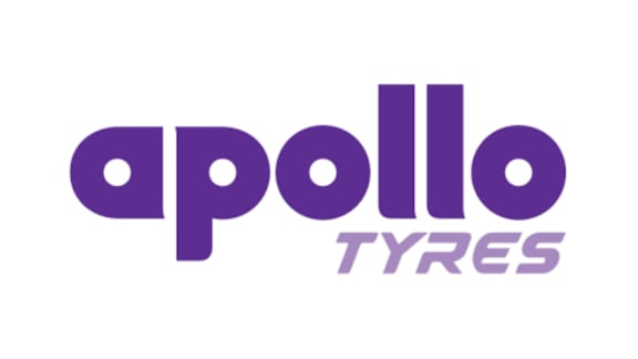 A high-tech tyre manufacturing line showing truck and passenger car radial tyres at an Apollo Tyres factory.