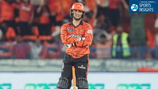 Abhishek Sharma in his orange Sunrisers Hyderabad jersey, standing with arms crossed and a confident smile at the Rajiv Gandhi International Stadium. The top right corner features a "Sports Insights" logo.