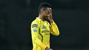Akeal Hosein of Chennai Super Kings performing his signature "Mask" celebration, placing his hand over his face after taking a wicket against Mumbai Indians at the Wankhede Stadium.