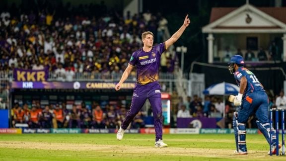 Cameron Green in the KKR purple jersey preparing to bowl at Eden Gardens.