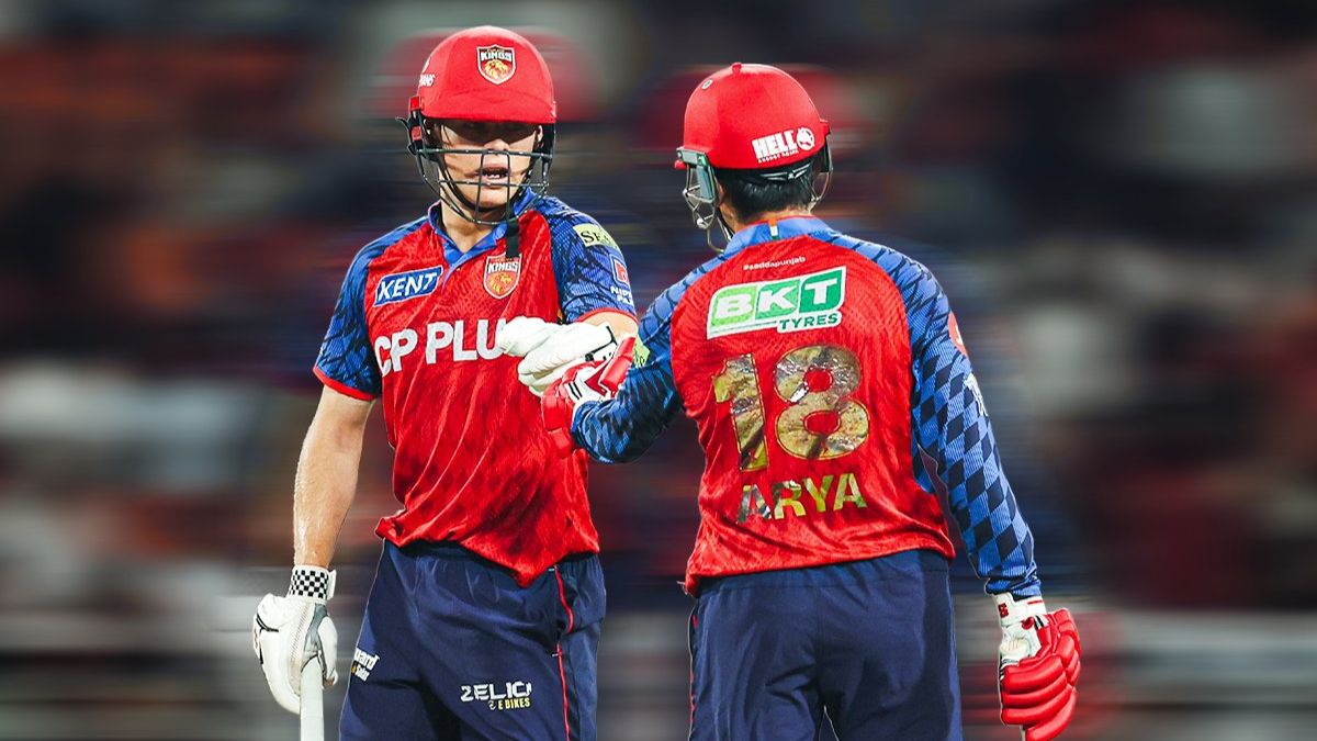 A dynamic shot from IPL 2026 Match 29 at Mullanpur Stadium featuring Punjab Kings (PBKS) openers Priyansh Arya and Cooper Connolly. Priyansh Arya, wearing jersey number 18, is seen from the back high-fiving Connolly after their record-shattering 184-run opening partnership. Both players are in their red and blue PBKS kits with helmets on.