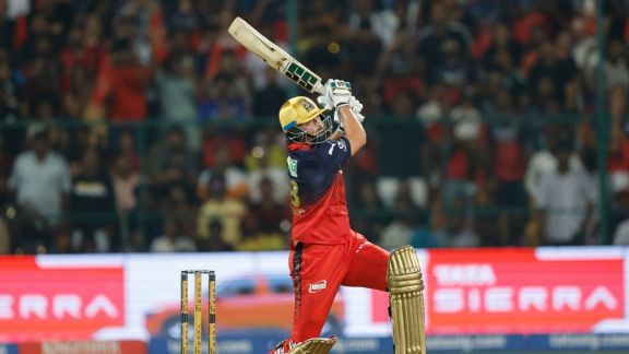 Tim David in action for RCB hitting a six against CSK to reach 250 runs in IPL 2026.