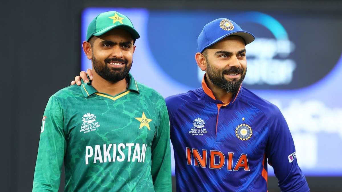 Virat Kohli and Babar Azam sharing a friendly moment on the field, used to compare Kohli's ₹1,050 crore net worth with Babar Azam's record-breaking T20 statistics in April 2026.