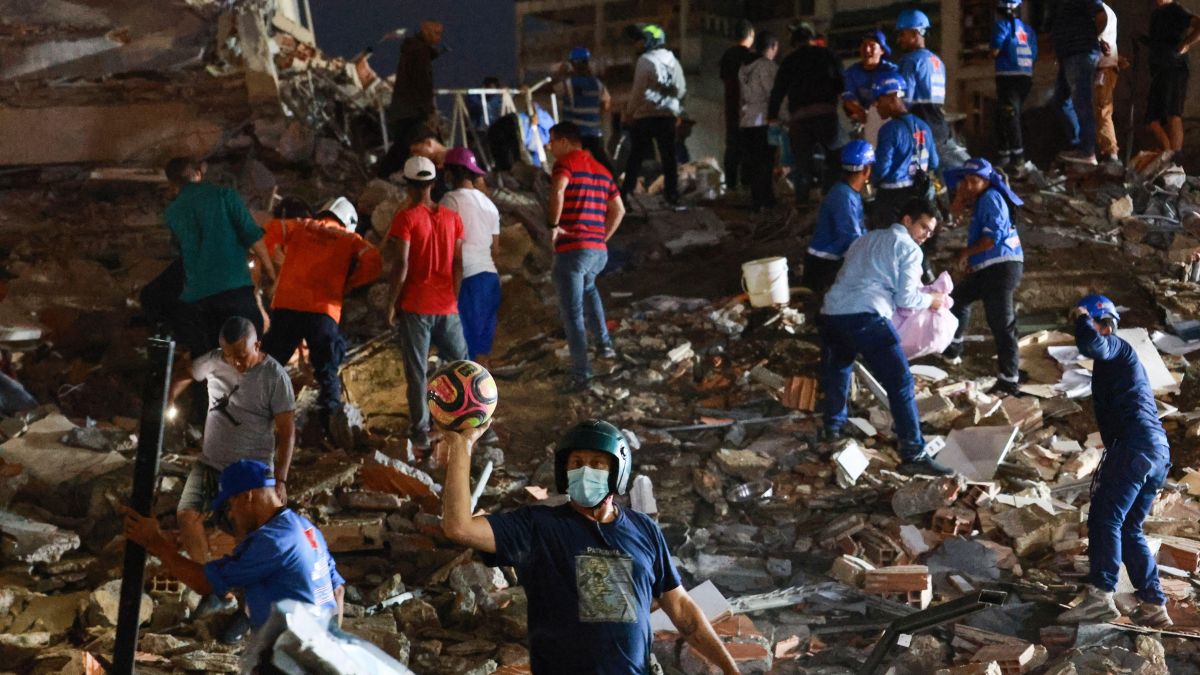 Rescue workers searching through rubble in urban area