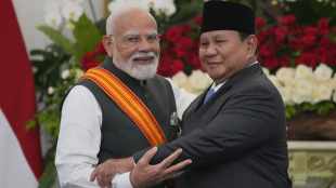 Indian Prime Minister Narendra Modi and Indonesian President Prabowo Subianto embrace after a joint press conference following their meetin in Jakarta (AP Photo)