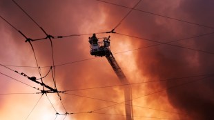 Firefighters try to put out a fire at a city book market following a Russian missile attack in Kyiv on August 16 (Representational image/AP)
